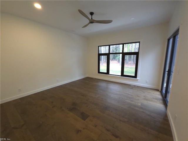 empty room with recessed lighting, baseboards, dark wood finished floors, and a ceiling fan