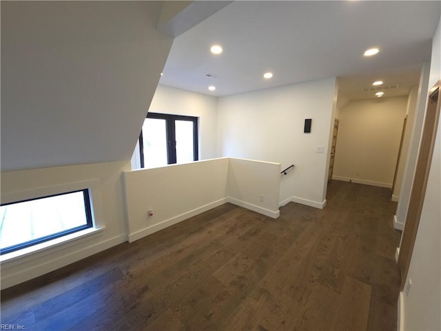 interior space featuring dark wood-type flooring, recessed lighting, baseboards, and visible vents