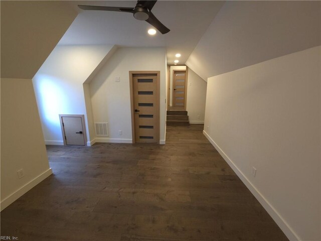 bonus room with visible vents, dark wood-type flooring, baseboards, lofted ceiling, and a ceiling fan