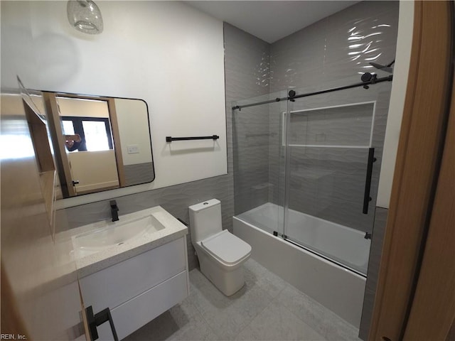 full bathroom with toilet, vanity, and shower / bath combination with glass door