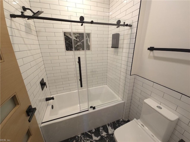 full bath featuring tile walls, toilet, and bath / shower combo with glass door