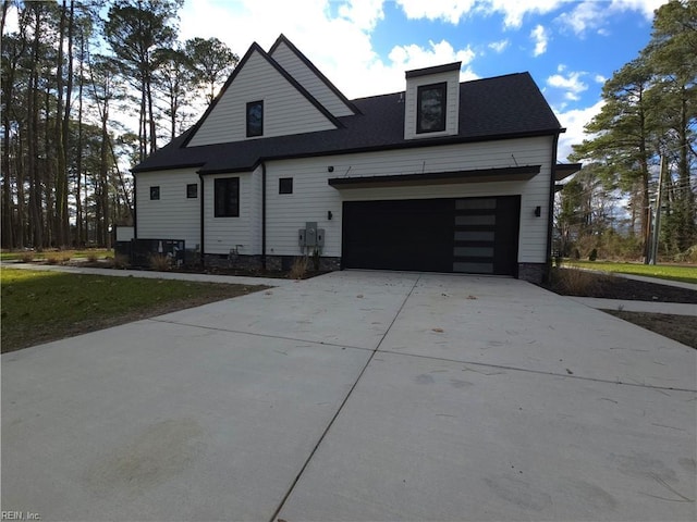 view of front of property featuring an attached garage and concrete driveway