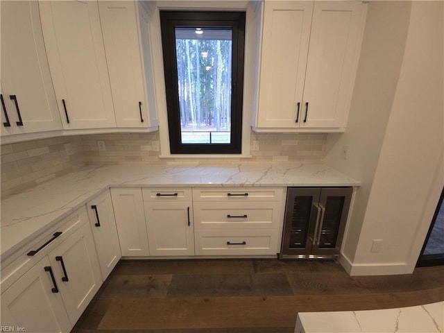 bar featuring backsplash, baseboards, wine cooler, and dark wood-type flooring