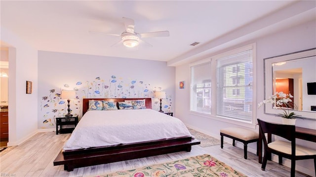 bedroom with visible vents, light wood-type flooring, and baseboards