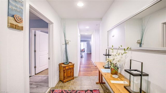 hallway featuring light tile patterned floors and recessed lighting