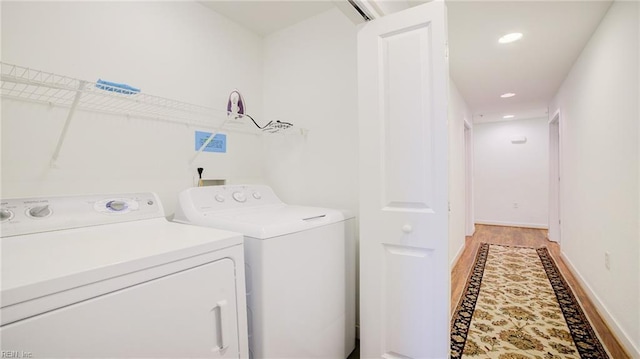 laundry area with washer and dryer, laundry area, recessed lighting, and light wood finished floors