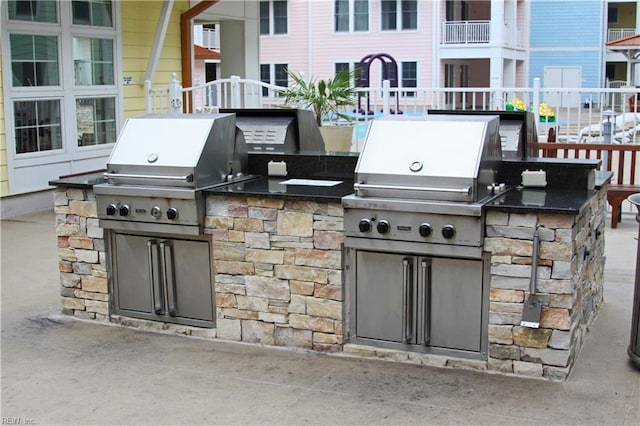 view of patio / terrace featuring grilling area, exterior kitchen, and fence