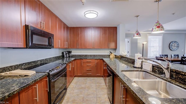 kitchen featuring dark stone counters, light tile patterned floors, hanging light fixtures, black appliances, and a sink