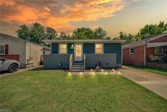 view of front of property featuring a front yard and brick siding