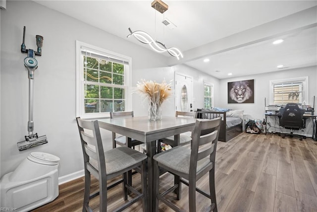 dining room with a wealth of natural light, recessed lighting, and wood finished floors