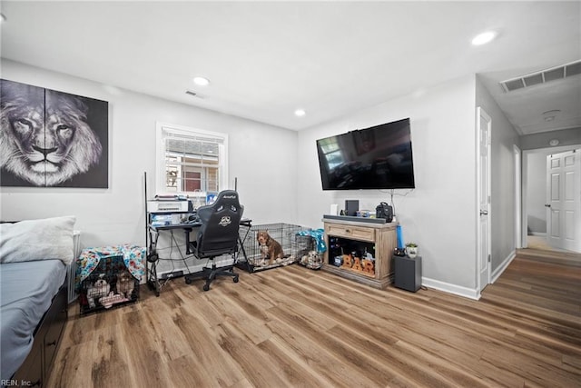 interior space featuring recessed lighting, wood finished floors, and visible vents