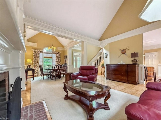 living room featuring a fireplace with flush hearth, high vaulted ceiling, ornamental molding, wood finished floors, and stairs