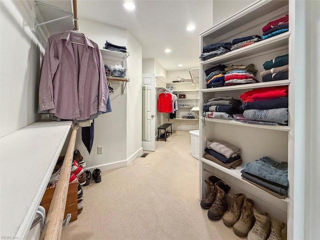 walk in closet featuring carpet