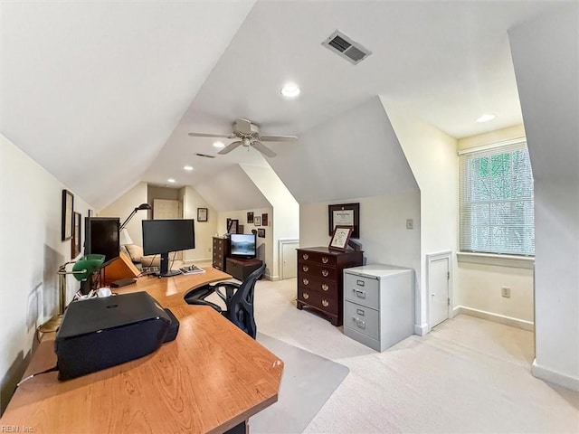 office with a ceiling fan, visible vents, baseboards, lofted ceiling, and light colored carpet