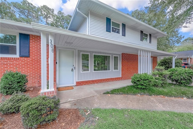 property entrance with brick siding