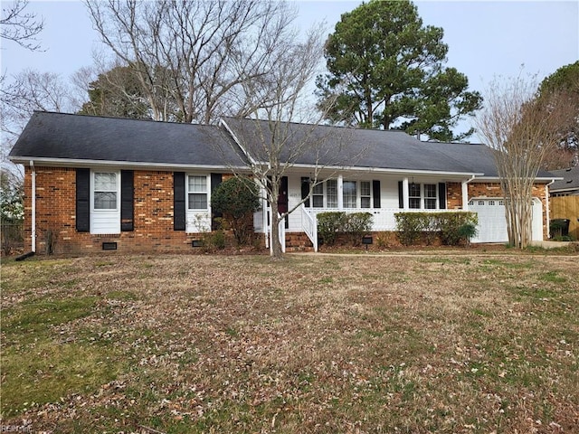 ranch-style home featuring brick siding, a porch, a front yard, crawl space, and an attached garage