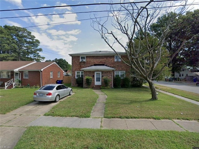 traditional home with brick siding, driveway, and a front lawn