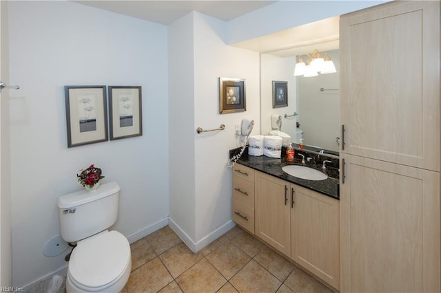 half bathroom featuring tile patterned flooring, baseboards, a chandelier, toilet, and vanity