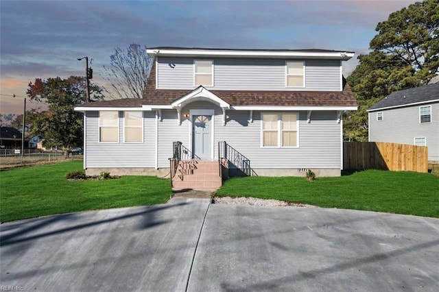 bungalow featuring a front yard, fence, and roof with shingles