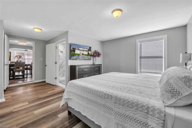 bedroom with baseboards and wood finished floors