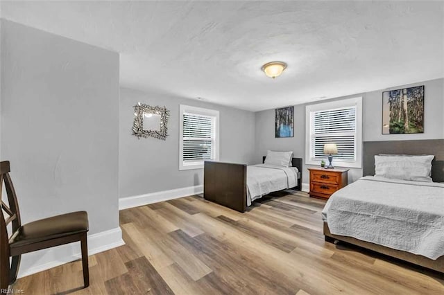 bedroom featuring light wood-style flooring and baseboards