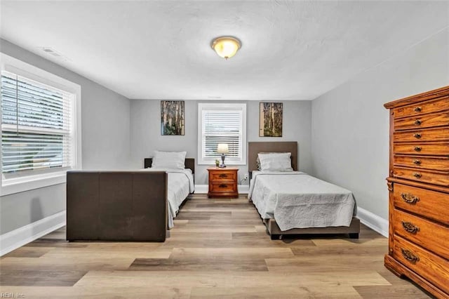 bedroom featuring baseboards and wood finished floors