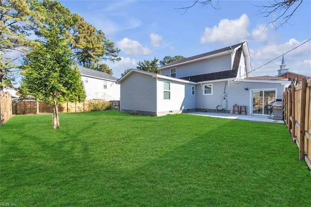 rear view of property with a lawn, a patio, a fenced backyard, and roof with shingles