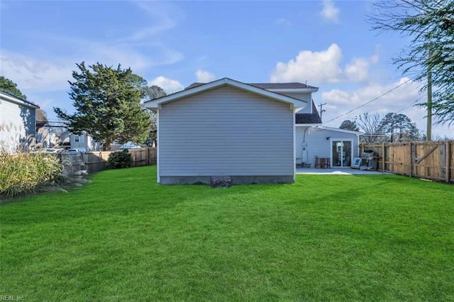 back of property with a patio, a yard, a fenced backyard, and french doors