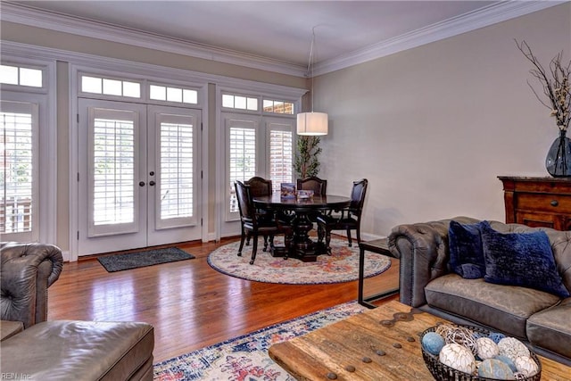 living area featuring french doors, wood finished floors, and crown molding