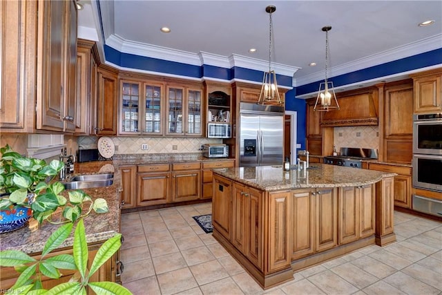 kitchen with crown molding, a warming drawer, brown cabinets, and appliances with stainless steel finishes