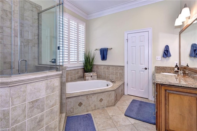 bathroom featuring a garden tub, ornamental molding, a stall shower, tile patterned floors, and vanity