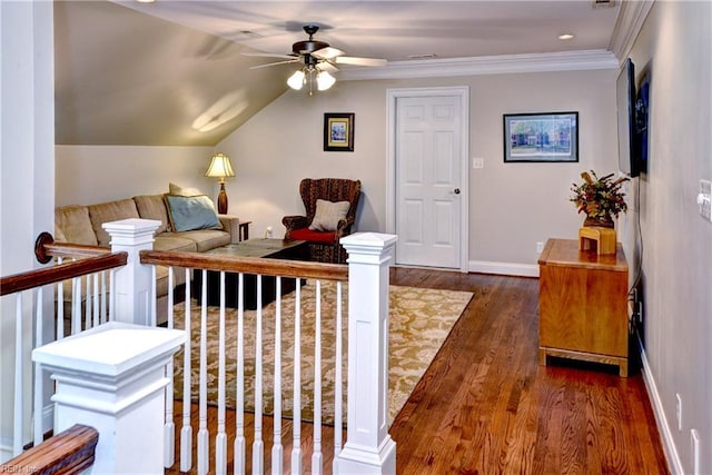 living room with ceiling fan, baseboards, vaulted ceiling, ornamental molding, and dark wood-style flooring