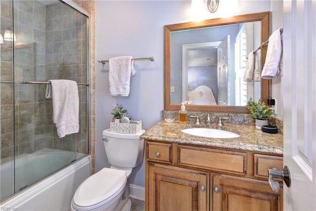 bathroom featuring combined bath / shower with glass door, toilet, and vanity