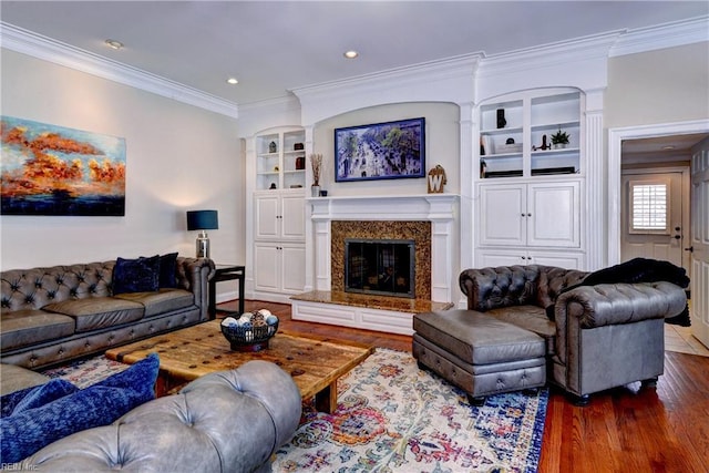 living area featuring a fireplace, crown molding, and wood finished floors