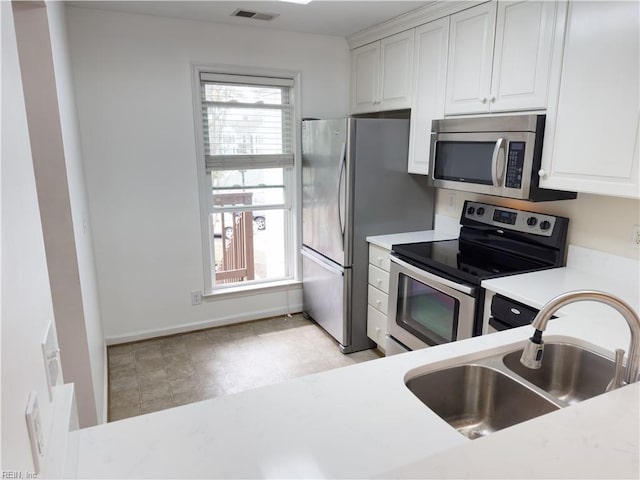 kitchen featuring a sink, stainless steel appliances, visible vents, and a wealth of natural light