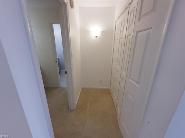 hall with light carpet and baseboards