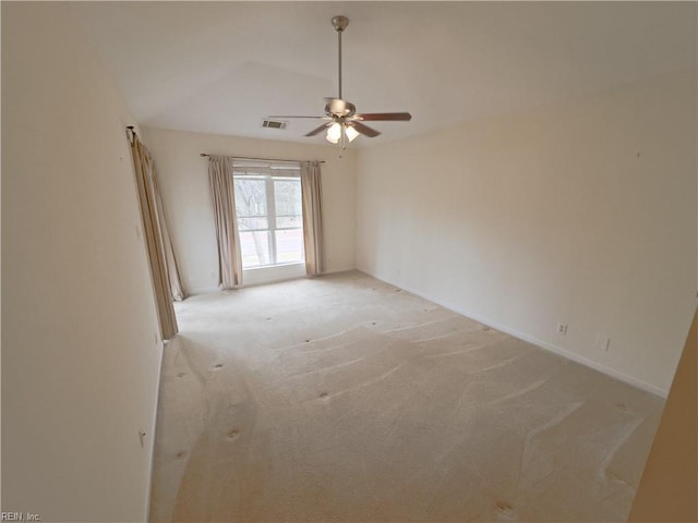 unfurnished room featuring visible vents, light carpet, a ceiling fan, baseboards, and vaulted ceiling