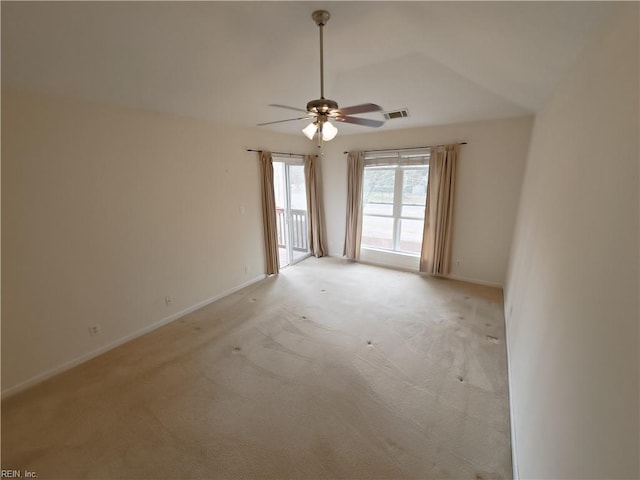 unfurnished room featuring baseboards, light colored carpet, ceiling fan, and vaulted ceiling