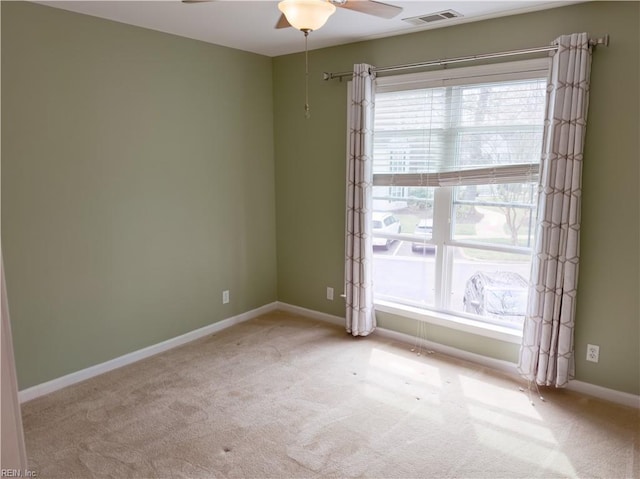 empty room with visible vents, plenty of natural light, and baseboards