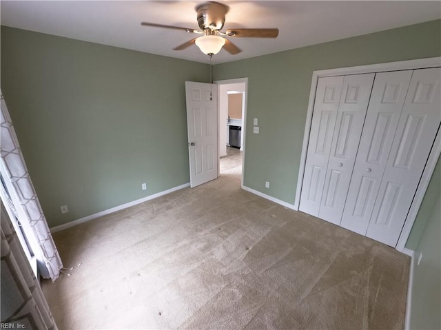 unfurnished bedroom featuring a ceiling fan, baseboards, a closet, and light carpet