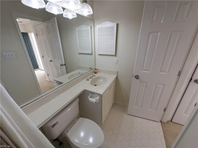 bathroom featuring tile patterned floors, toilet, and vanity