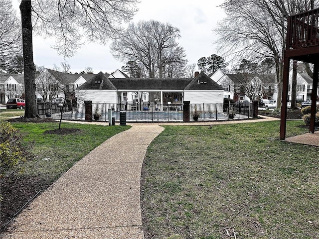 view of community with a pool, a patio, a yard, and fence