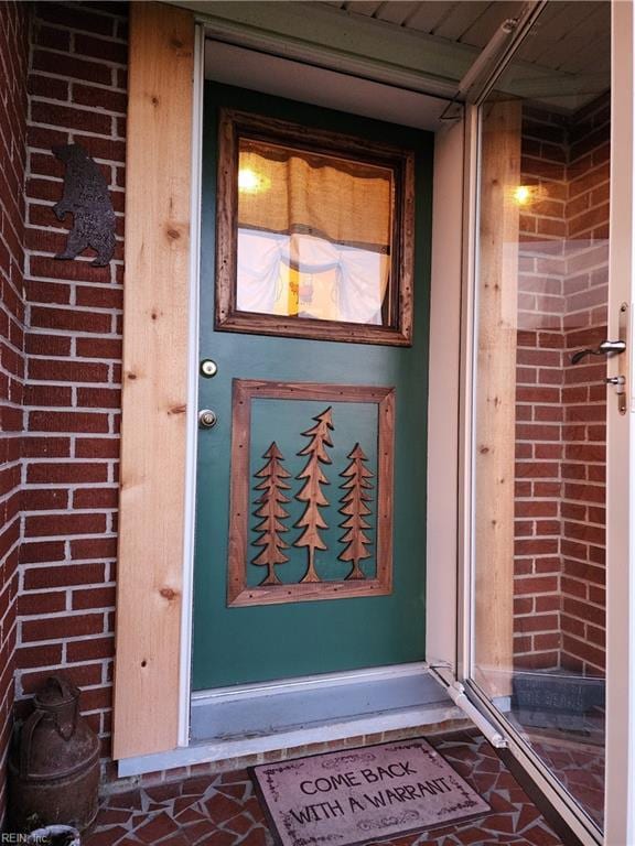 entrance to property with brick siding