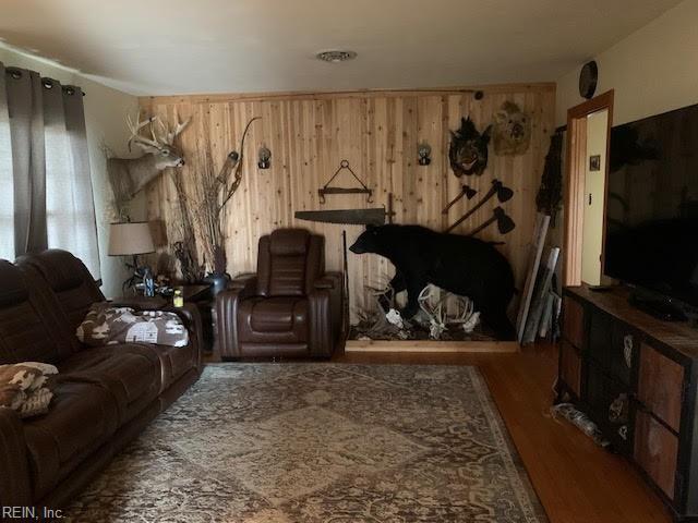living area featuring wood finished floors and wood walls