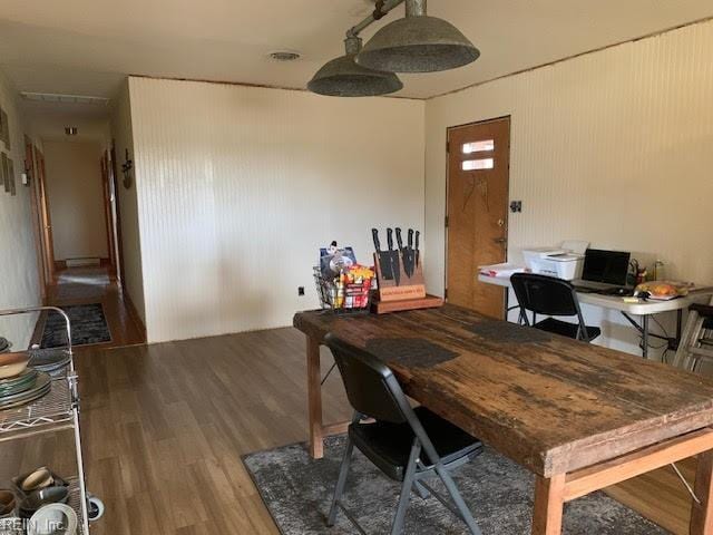 dining space with wood finished floors