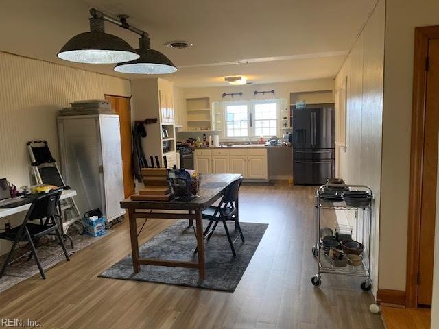 dining area with wood finished floors and visible vents