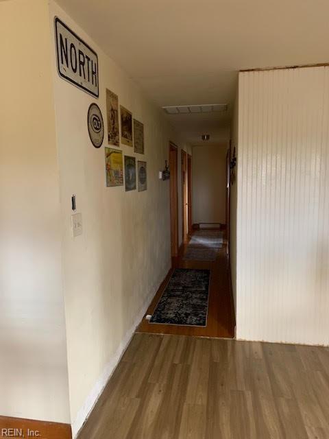 corridor with visible vents and wood finished floors