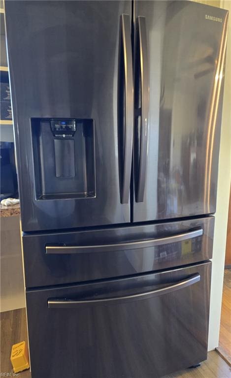 details with stainless steel fridge and light wood finished floors