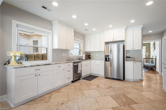 kitchen with white cabinets, recessed lighting, visible vents, and appliances with stainless steel finishes