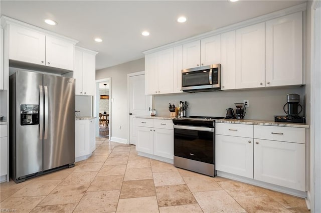 kitchen featuring white cabinetry, recessed lighting, baseboards, and stainless steel appliances